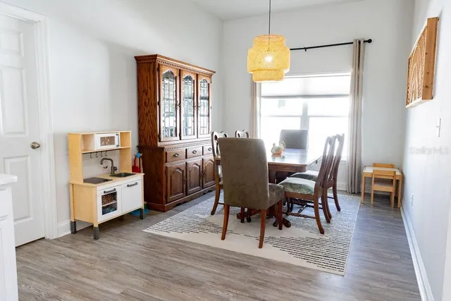 a view of a dining room with furniture window and wooden floor