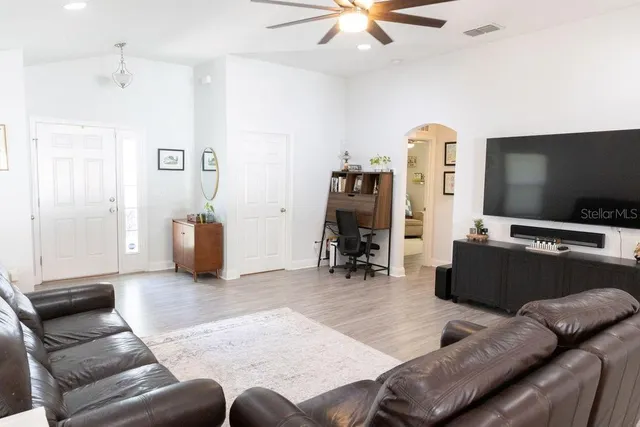 a living room with furniture and a flat screen tv