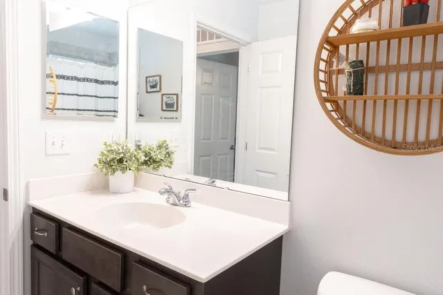 a bathroom with a sink a mirror and a toilet