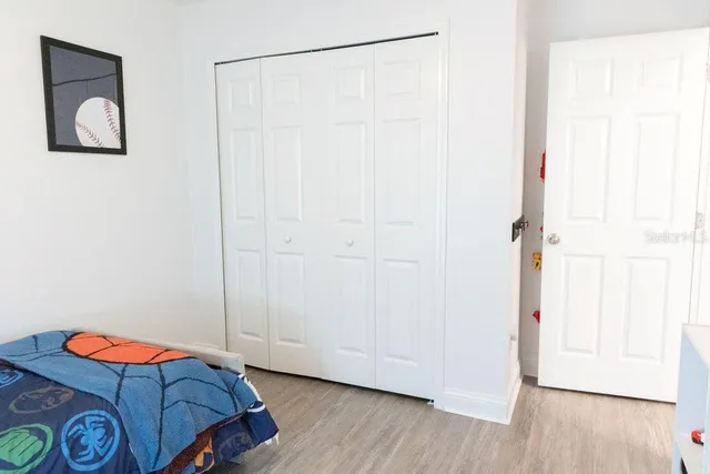 a room with closet and wooden floor