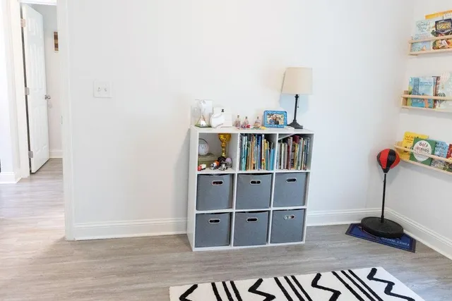 a room with shelf and book shelf