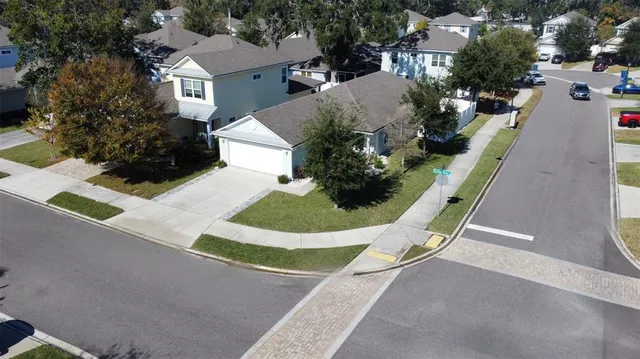 an aerial view of a house with a garden and mountain view
