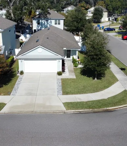 an aerial view of a house with a yard