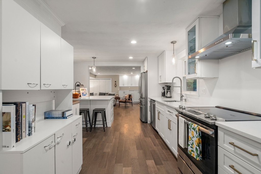 62 Gregory Road Framingham, MA 01701 - Photo 11 of 42 a kitchen with cabinets and wooden floor
