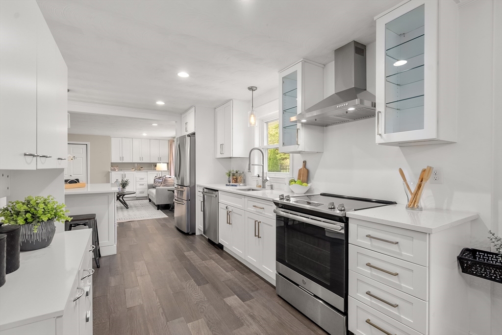 62 Gregory Road Framingham, MA 01701 - Photo 14 of 42 a kitchen with a white stove top oven and white cabinets