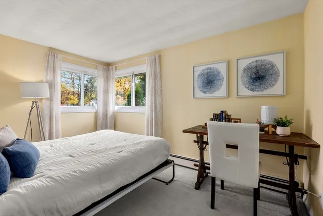 a bedroom with a bed and a table in it