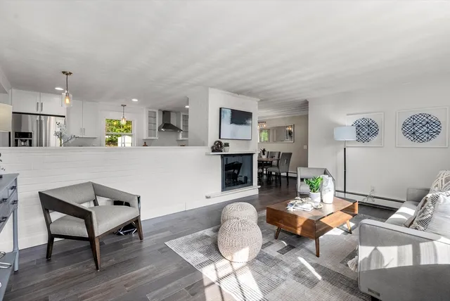 a living room with furniture and a kitchen view