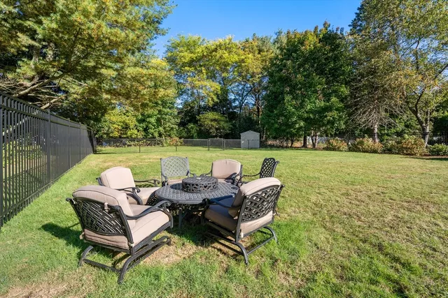 a backyard of a house with table and chairs