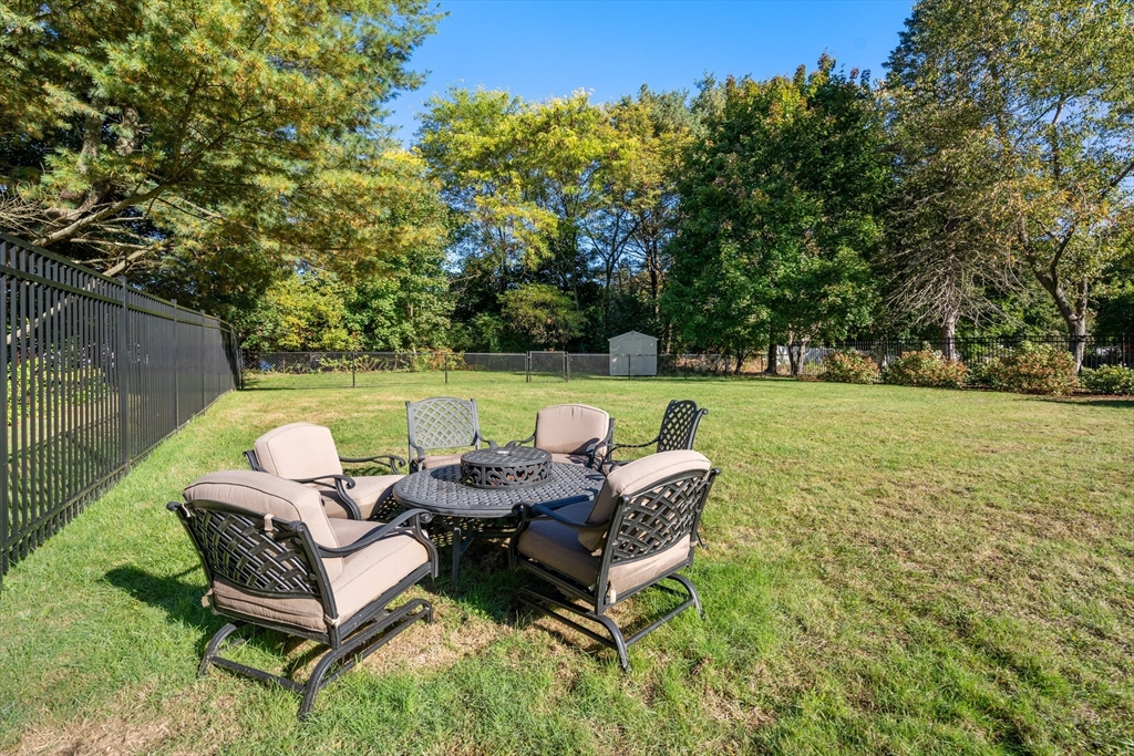 62 Gregory Road Framingham, MA 01701 - Photo 40 of 42 a backyard of a house with table and chairs