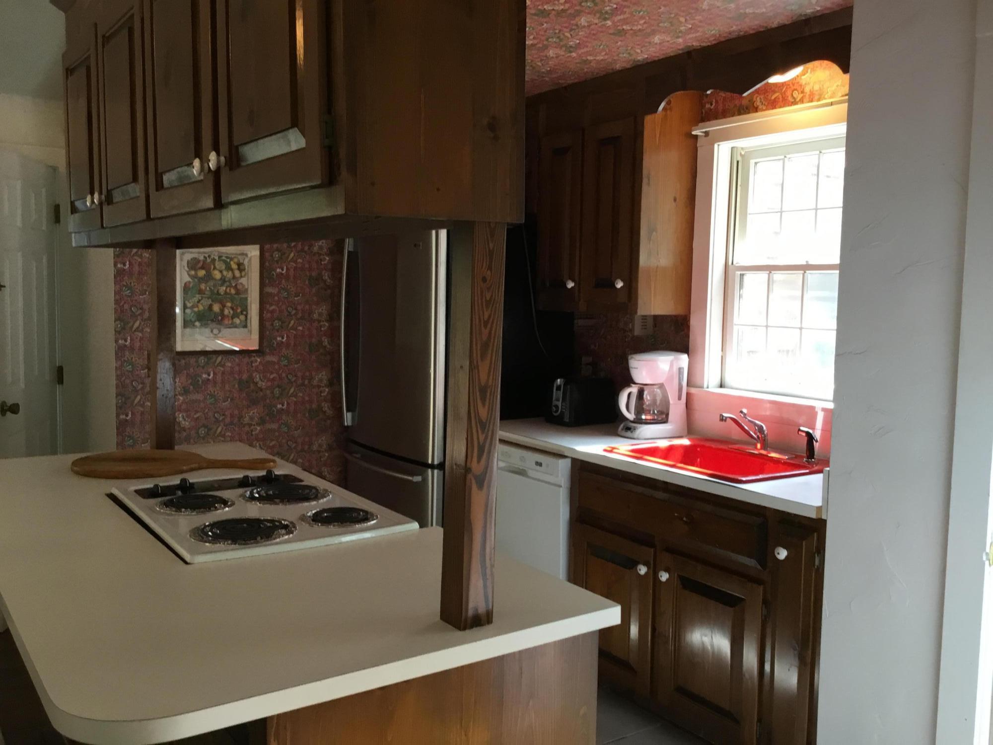 14 Amos Landing Road Mashpee, MA 02649 - Photo 8 of 34 a kitchen with stainless steel appliances granite countertop a stove and a refrigerator