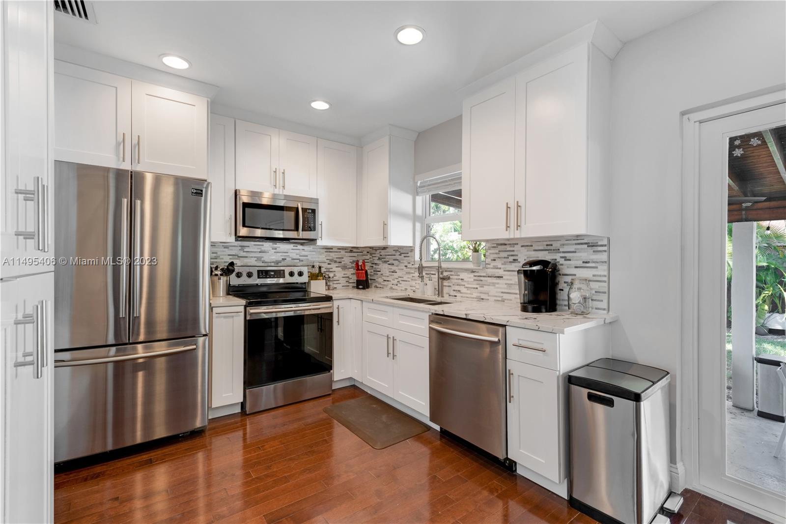 2465 Southwest 21st Terrace Miami, FL 33145 - Photo 14 of 45 a kitchen with a refrigerator stove and microwave