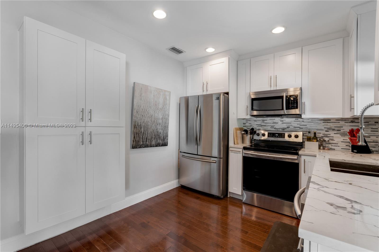 2465 Southwest 21st Terrace Miami, FL 33145 - Photo 15 of 45 a kitchen with a refrigerator stove and microwave