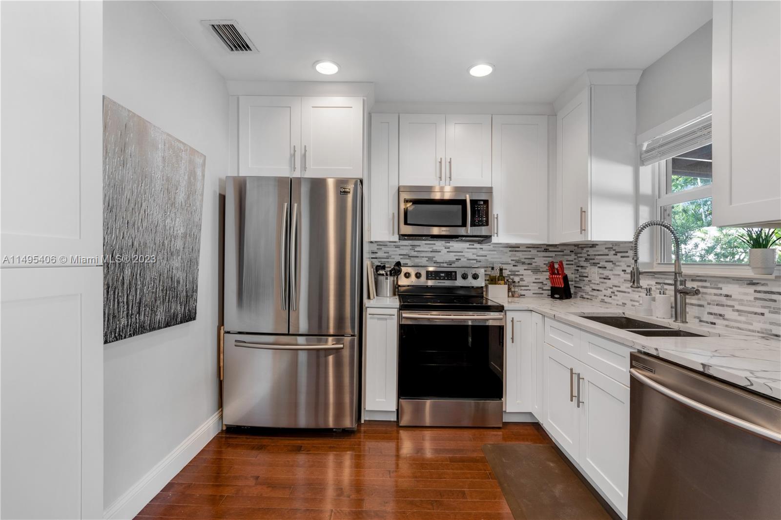 2465 Southwest 21st Terrace Miami, FL 33145 - Photo 16 of 45 a kitchen with stainless steel appliances a refrigerator sink and microwave