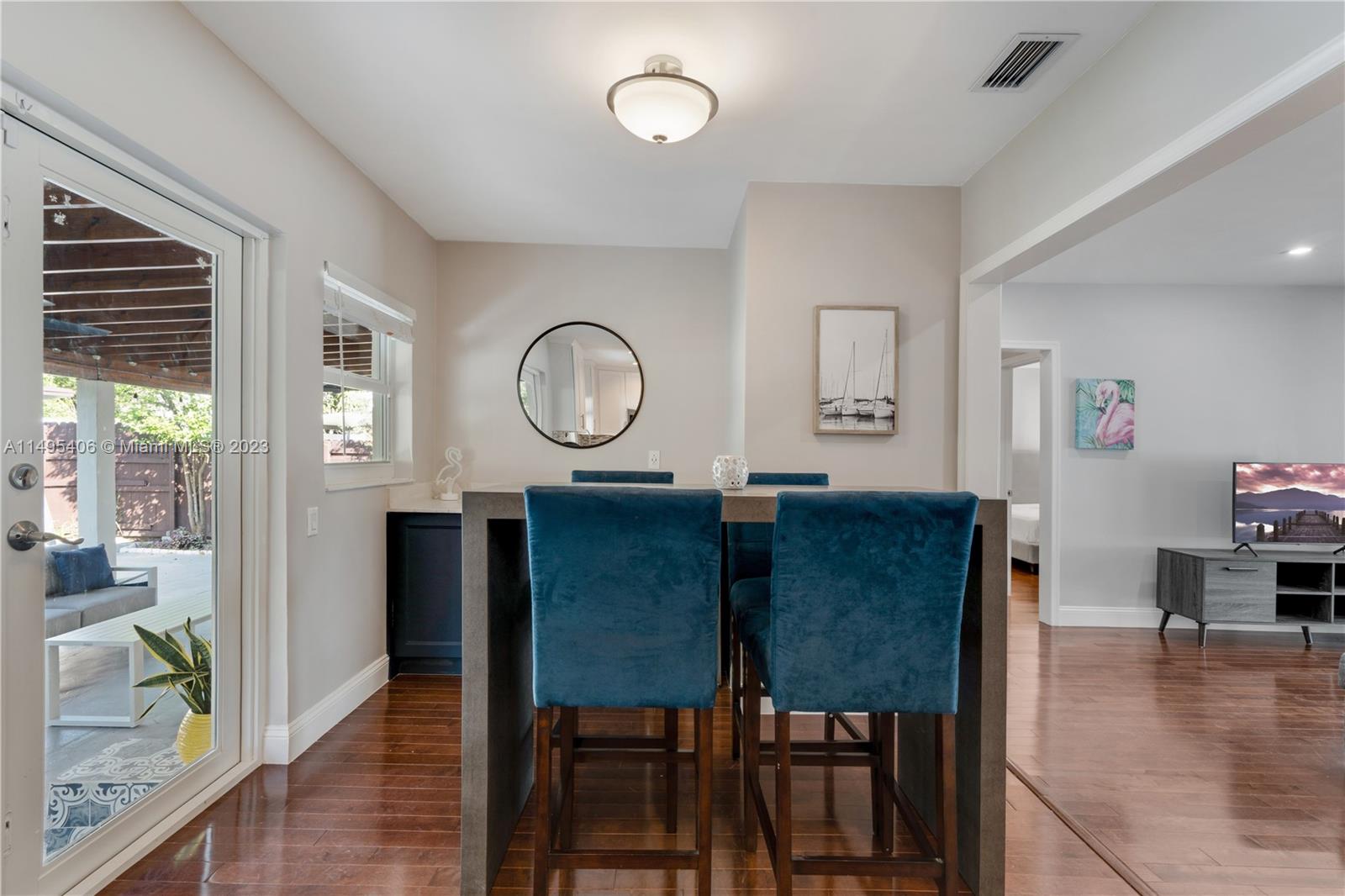 2465 Southwest 21st Terrace Miami, FL 33145 - Photo 17 of 45 a view of a dining room with furniture and wooden floor