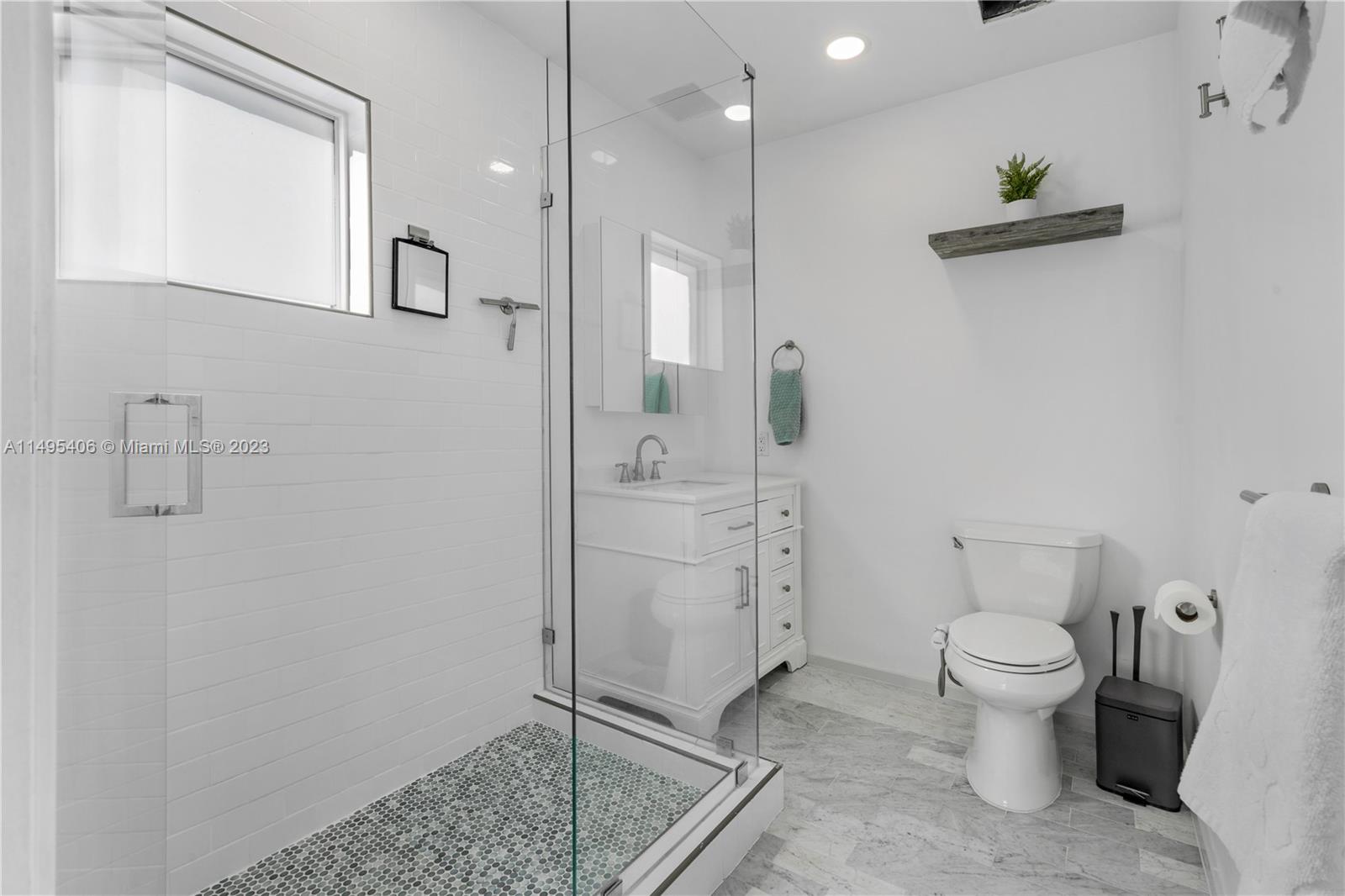 2465 Southwest 21st Terrace Miami, FL 33145 - Photo 21 of 45 a bathroom with a granite countertop sink a toilet and a mirror