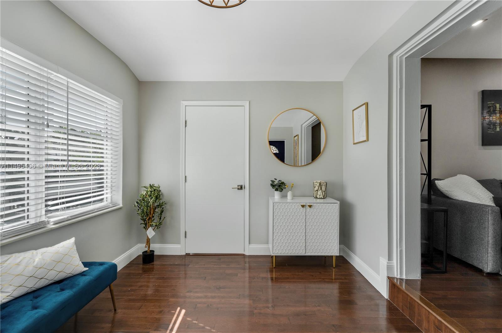 2465 Southwest 21st Terrace Miami, FL 33145 - Photo 7 of 45 a hallway with painting on the wall and a window