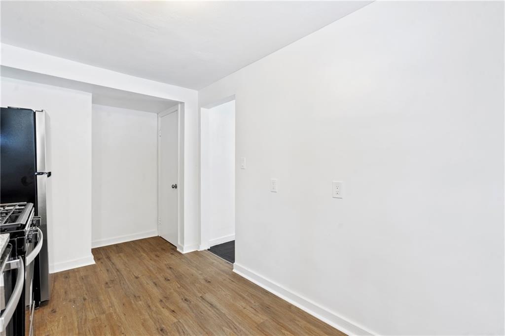 2041 Lindsay Road Pittsburgh, PA 15221 - Photo 11 of 24 a view of a room with wooden floor and a flat screen tv