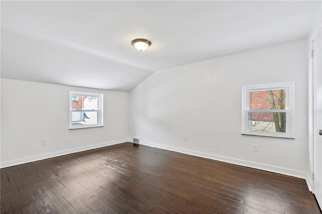 2041 Lindsay Road Pittsburgh, PA 15221 - Photo 12 of 24 a view of an empty room with wooden floor and a window