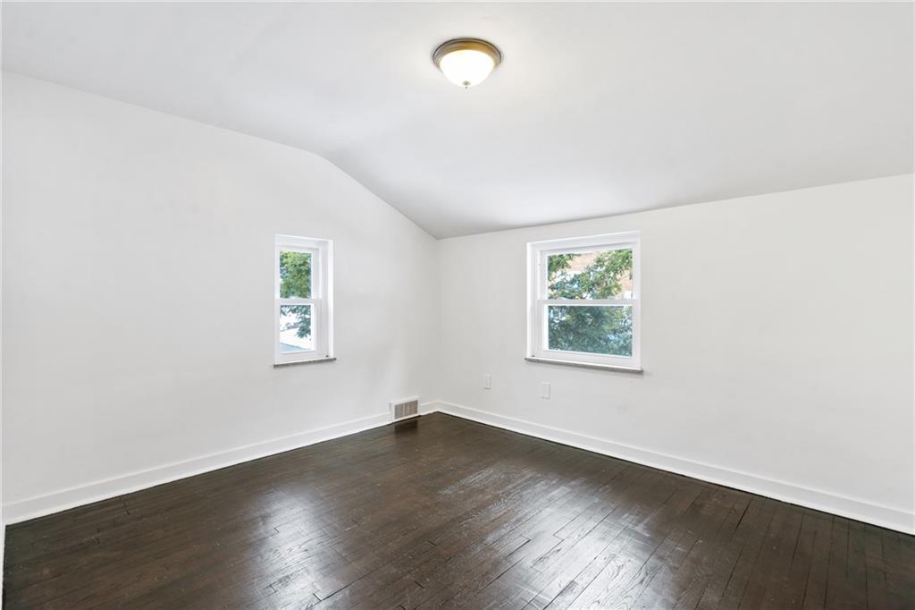 2041 Lindsay Road Pittsburgh, PA 15221 - Photo 15 of 24 an empty room with wooden floor and windows