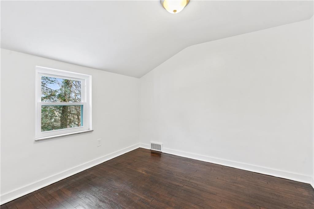 2041 Lindsay Road Pittsburgh, PA 15221 - Photo 17 of 24 a view of an empty room with wooden floor and a window