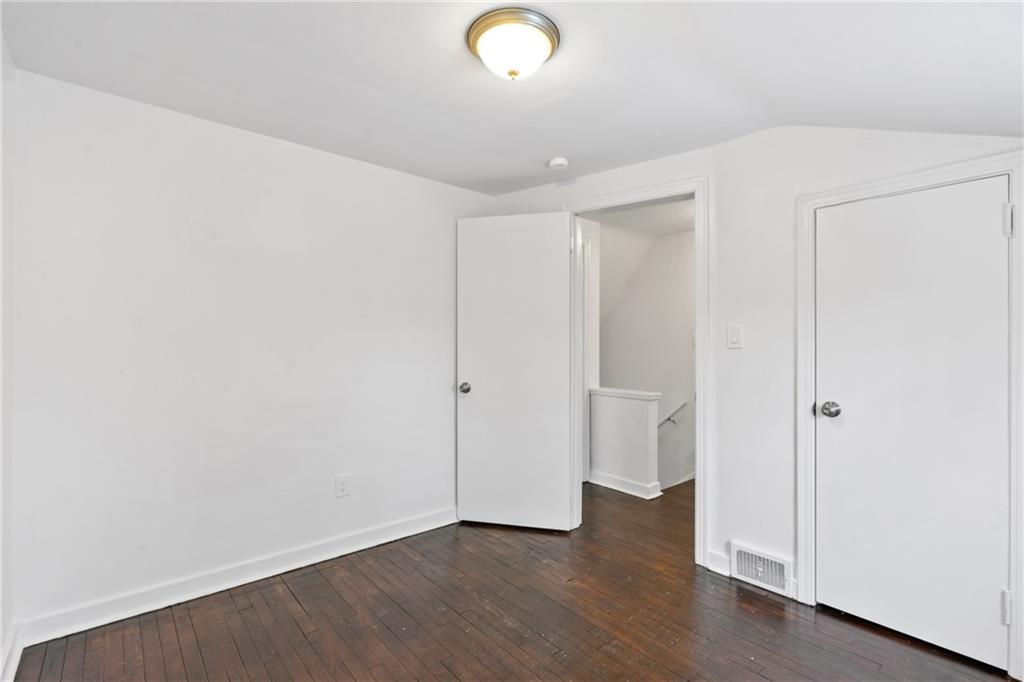 2041 Lindsay Road Pittsburgh, PA 15221 - Photo 18 of 24 a view of an empty room with wooden floor and window