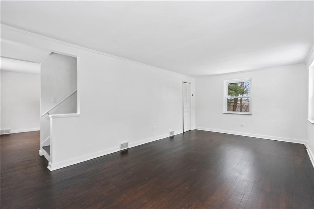 2041 Lindsay Road Pittsburgh, PA 15221 - Photo 4 of 24 a view of an empty room with wooden floor and a window