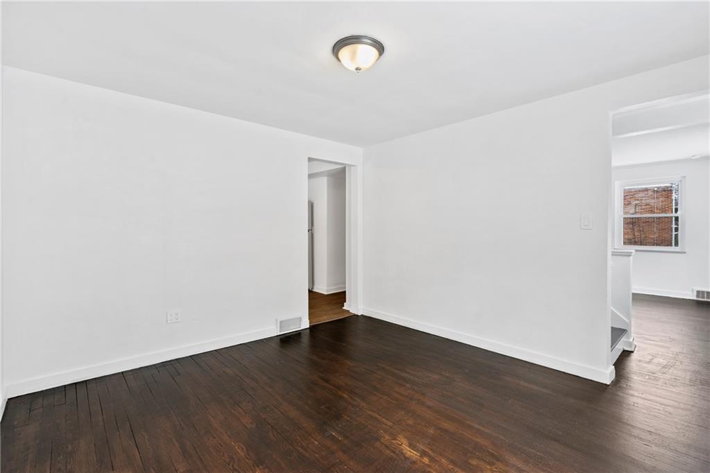 2041 Lindsay Road Pittsburgh, PA 15221 - Photo 6 of 24 an empty room with wooden floor and a window