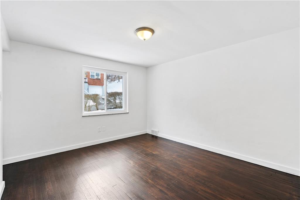 2041 Lindsay Road Pittsburgh, PA 15221 - Photo 7 of 24 a view of an empty room with wooden floor and a window