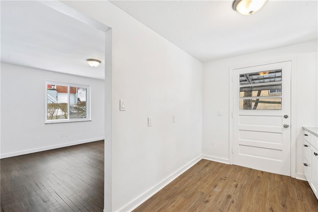 2041 Lindsay Road Pittsburgh, PA 15221 - Photo 8 of 24 an empty room with wooden floor and windows