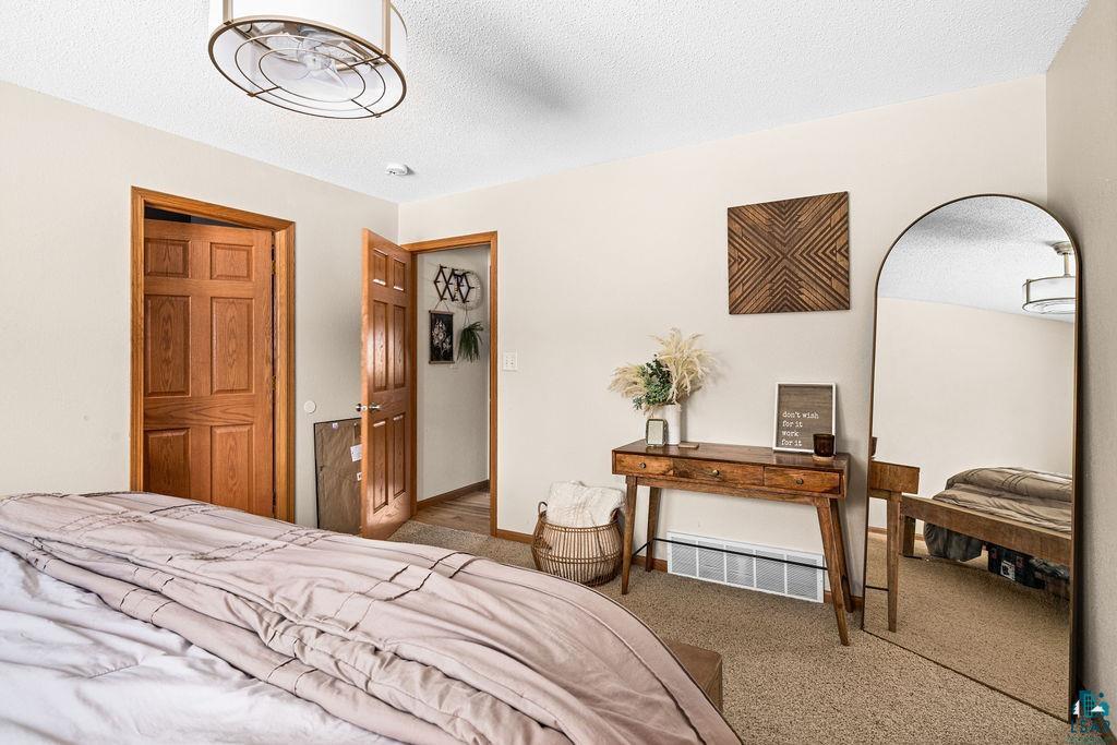 2783 Lauren Road Duluth, MN 55804 - Photo 23 of 47 Carpeted bedroom with a textured ceiling and a closet