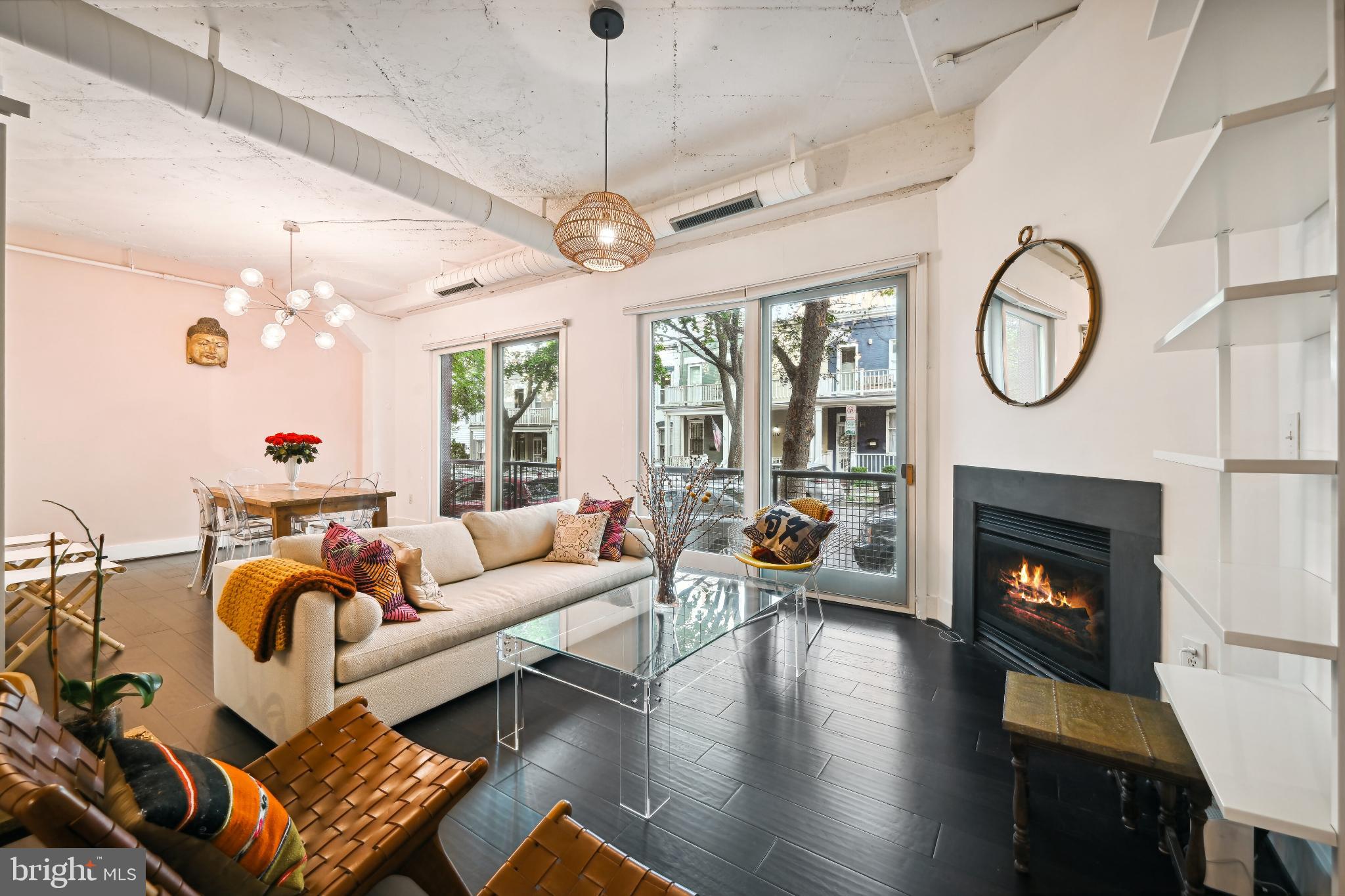1700 Kalorama Road Northwest, Unit 207 Washington, DC 20009 - Photo 1 of 40 a living room with furniture a fireplace and a chandelier