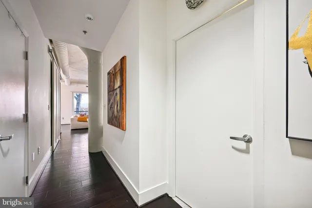a view of a hallway with wooden floor