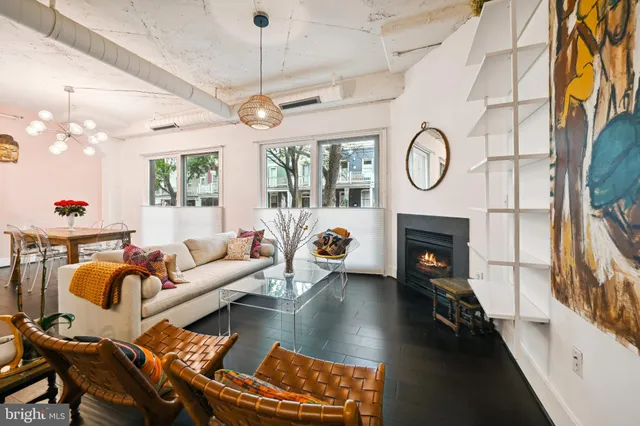 a living room with furniture a fireplace and a flat screen tv
