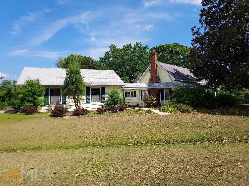 195 Dowdy Road Roopville, GA 30170 - Photo 1 of 1 a front view of a house with swimming pool and sitting area