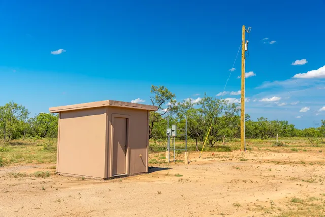 a view of a wooden deck with a yard
