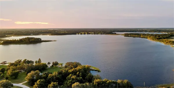a view of a lake with houses in the back