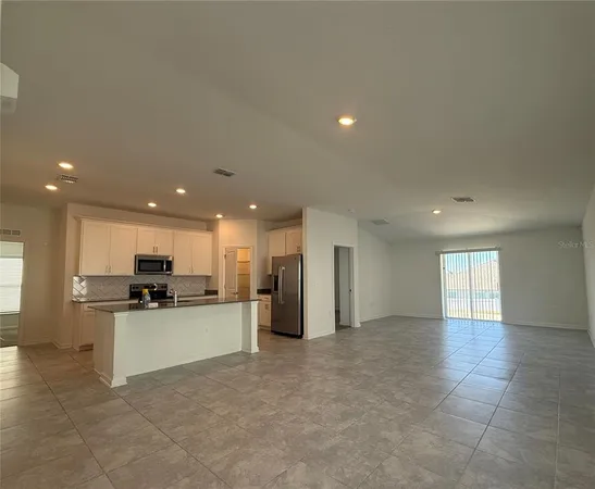 a view of a kitchen with a sink and stainless steel appliances