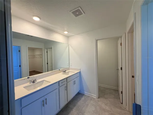 a bathroom with a double vanity sink mirror and double