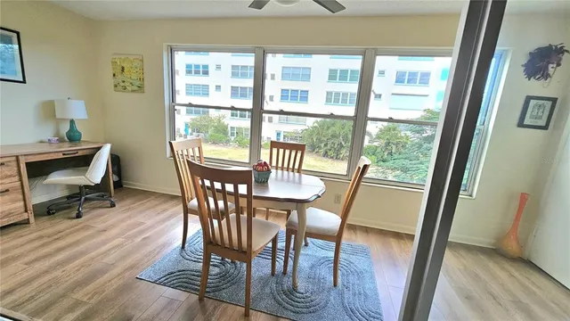 a view of a dining room with furniture window and wooden floor