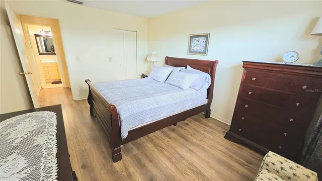 a bedroom with a bed and wooden floor