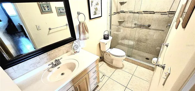 a bathroom with a sink and mirror with toilet