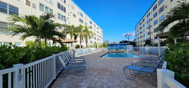 a backyard of a house with fountain table and chairs