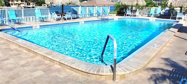 a swimming pool with outdoor seating and yard