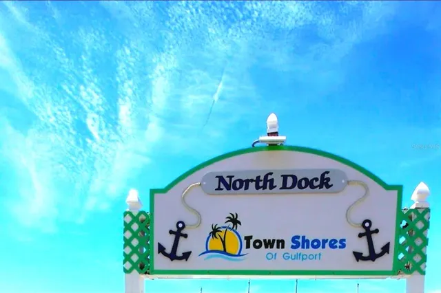 a view of a lake with boats and palm trees