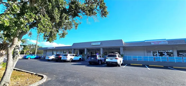 a view of a cars park in front of a building