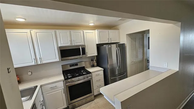a kitchen with a refrigerator stove and microwave