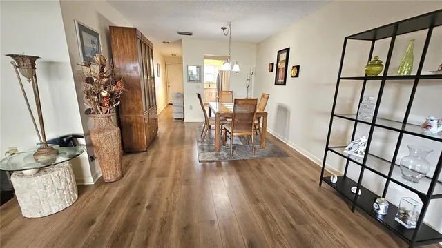 a view of a dining room with furniture window and wooden floor