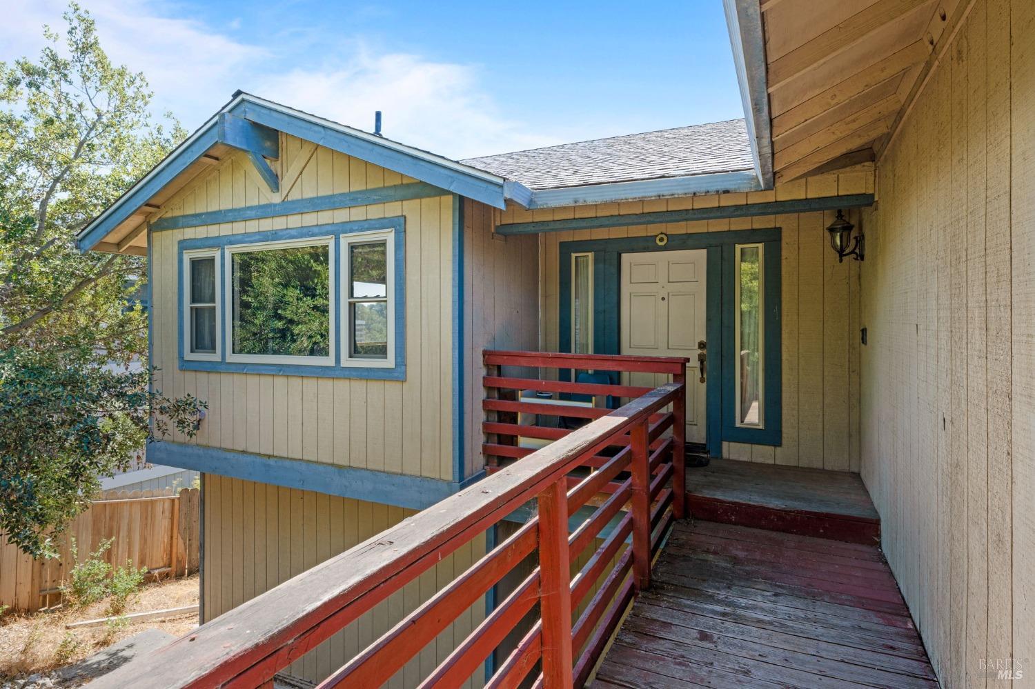 a view of house with deck and outdoor seating