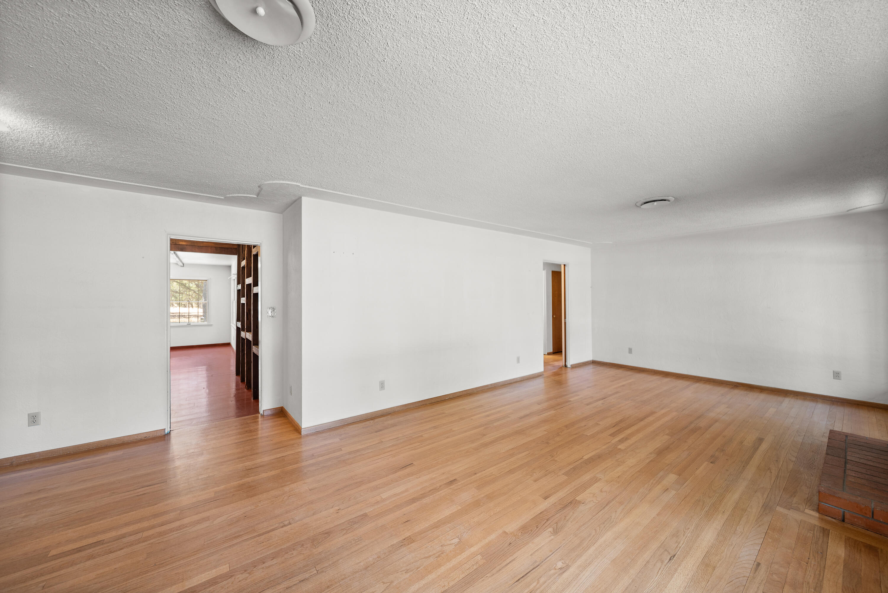 14575 Kinney Avenue Red Bluff, CA 96080 - Photo 11 of 43 a view of an empty room with wooden floor and a window