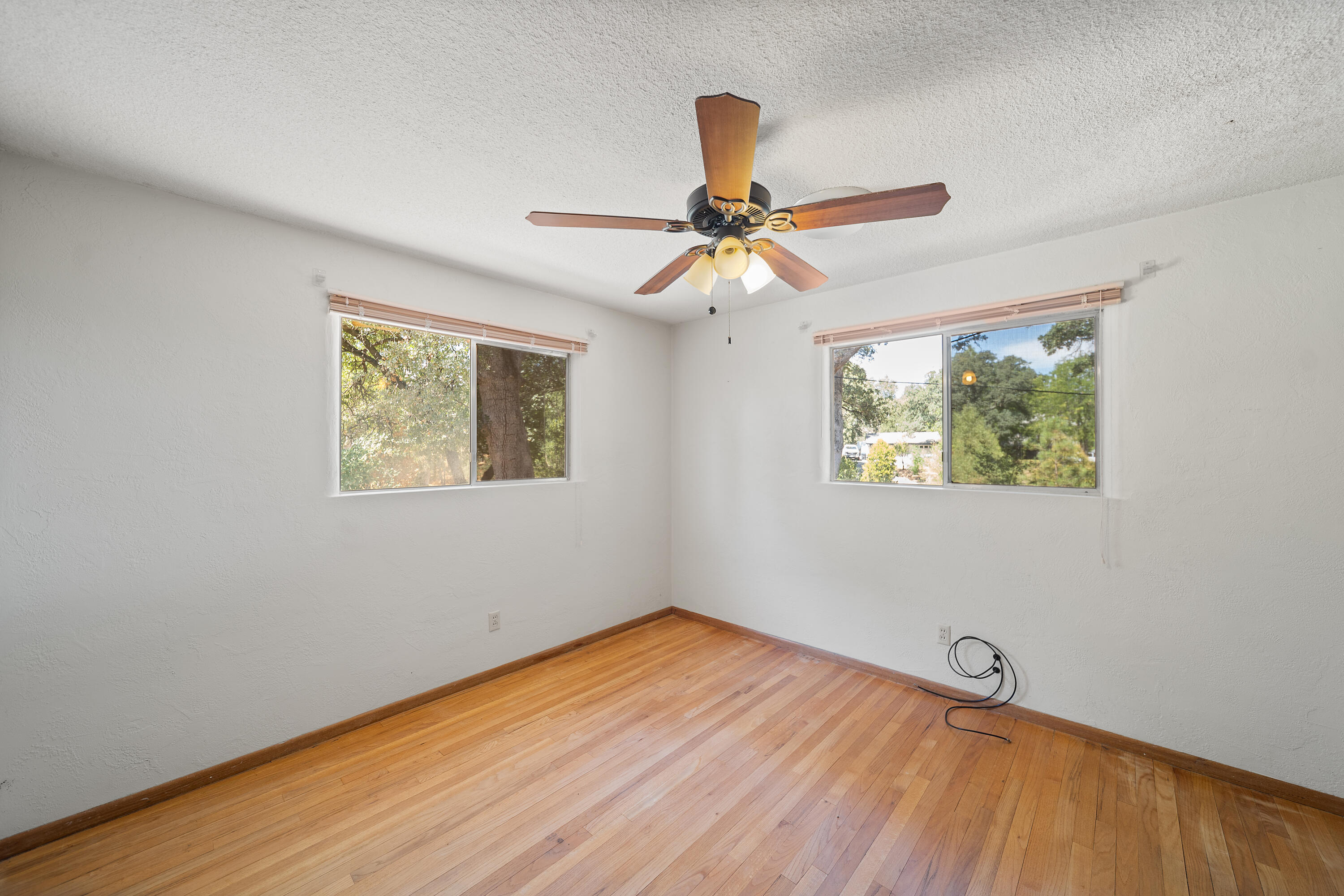14575 Kinney Avenue Red Bluff, CA 96080 - Photo 15 of 43 a view of an empty room with window and wooden floor